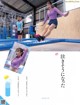 A woman jumping on a trampoline in a gymnasium. 