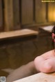 A woman sitting in a hot tub with her arms crossed.