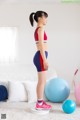 A woman standing on a balance board in a living room.